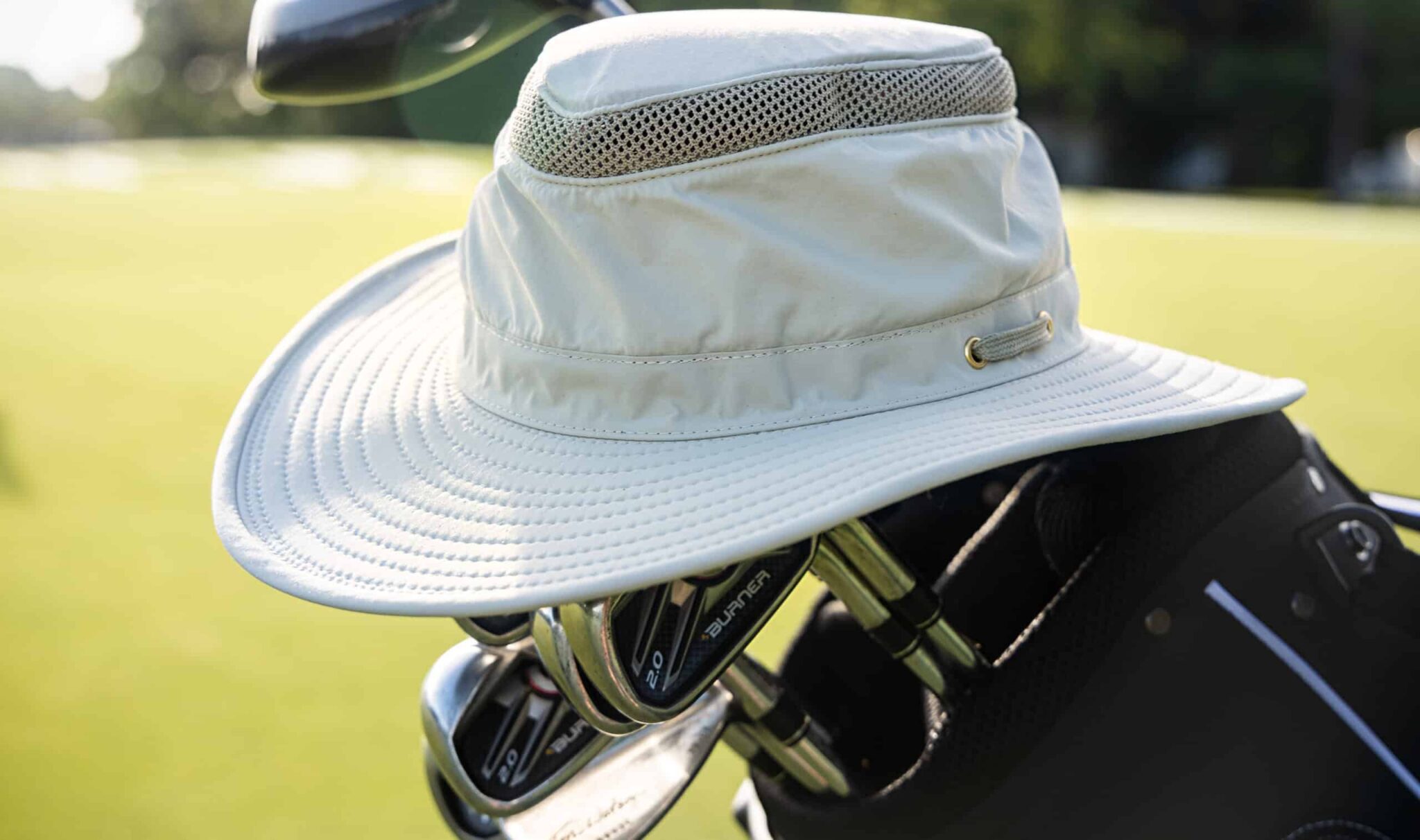Wide-brimmed hat on golf club bag.